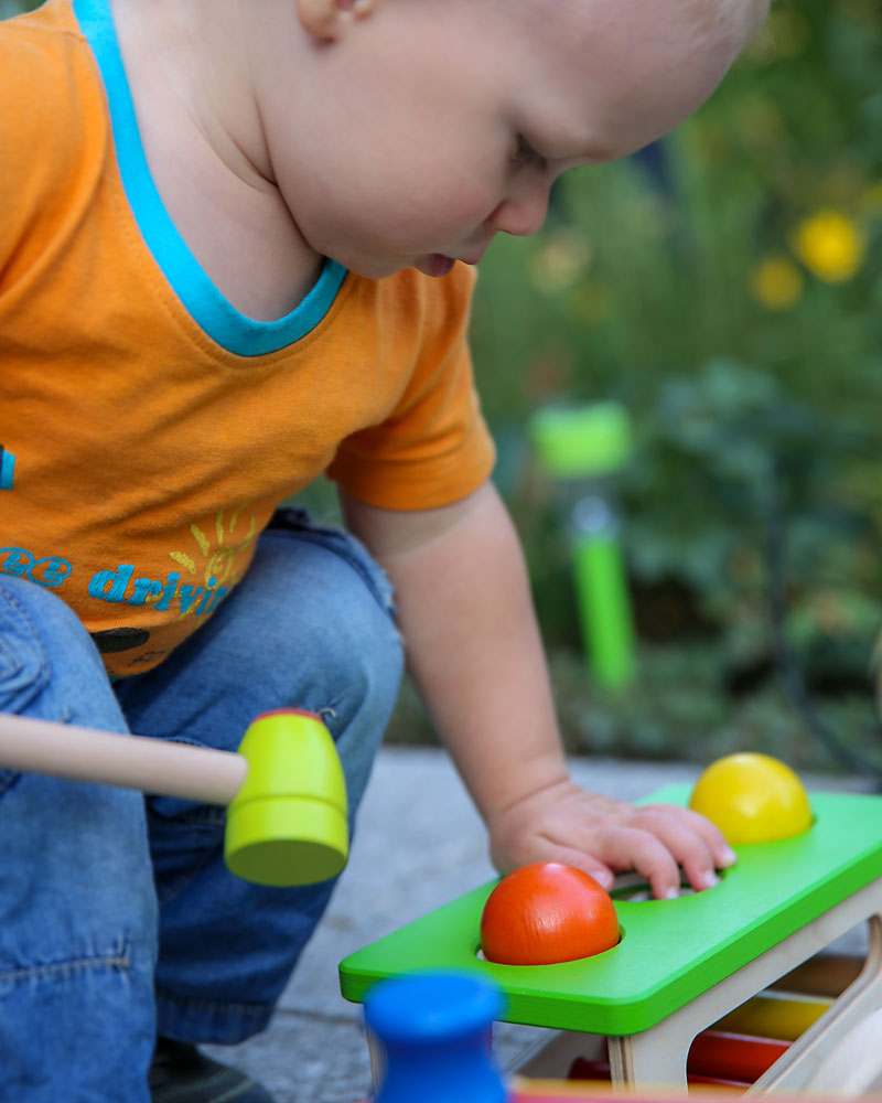 Baby with battino wooden toy by Selecta