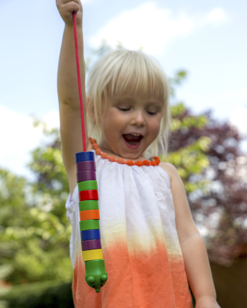 Child with threading caperpillar wooden toy by Selecta