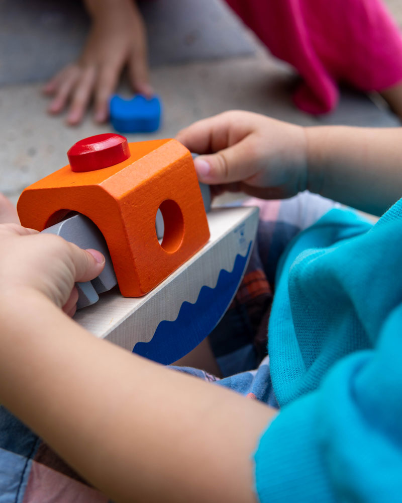 Baby with wippofant wooden toy by Selecta