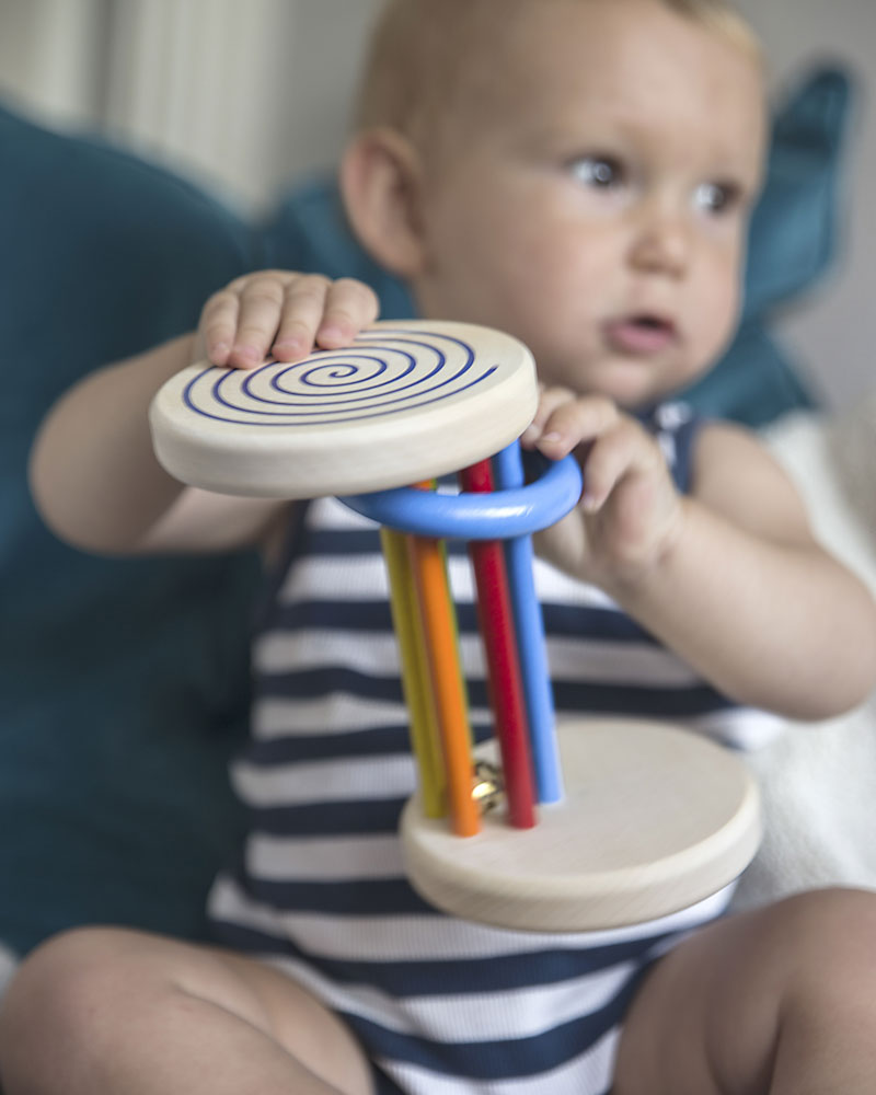 Child with rolldi wooden toy by selecta