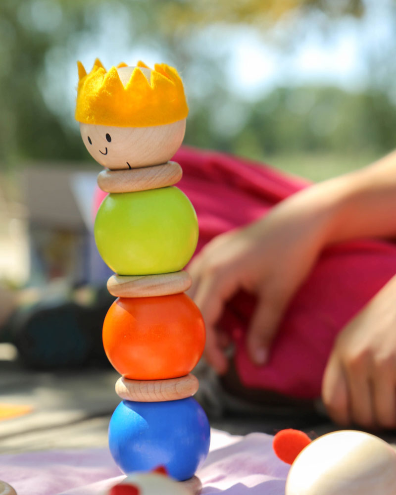 Child with stacking pair wooden toy by selecta